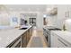 Modern kitchen featuring stainless steel appliances, white countertops, and an open design at 4520 W Moncrieff Pl, Denver, CO 80212
