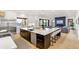 Open-concept kitchen with quartz countertops and stainless steel appliances at 4520 W Moncrieff Pl, Denver, CO 80212