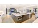Open kitchen with a large island, stainless steel appliances, and view of the living area at 4520 W Moncrieff Pl, Denver, CO 80212