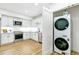 Efficient kitchen and laundry area features modern appliances, sleek cabinetry, and bright lighting at 4520 W Moncrieff Pl, Denver, CO 80212
