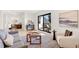 Bright living room with a modern sofa, contemporary furniture, and access to a balcony at 4520 W Moncrieff Pl, Denver, CO 80212