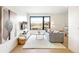 Bright living room features a large window, plush rug, and stylish decor at 4520 W Moncrieff Pl, Denver, CO 80212