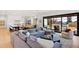 Spacious living room with a large couch, hardwood floors, and an open floor plan at 4520 W Moncrieff Pl, Denver, CO 80212