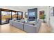 Inviting living room with a modern fireplace, hardwood floors, and large windows at 4520 W Moncrieff Pl, Denver, CO 80212