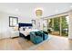 Spacious bedroom with a private balcony and stylish blue accents at 4520 W Moncrieff Pl, Denver, CO 80212