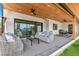 Inviting outdoor patio with comfortable seating, a wood ceiling, ceiling fans, and a BBQ area for entertaining at 4520 W Moncrieff Pl, Denver, CO 80212