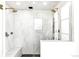 Luxurious marble shower with dual shower heads and a built-in bench at 4520 W Moncrieff Pl, Denver, CO 80212