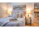 Comfortable bedroom featuring neutral tones, stylish bedding, and ambient lighting for a relaxing atmosphere at 1140 Columbine St # 106, Denver, CO 80206