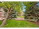Scenic courtyard with lush green lawn and mature trees providing a tranquil outdoor space at 1140 Columbine St # 106, Denver, CO 80206