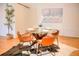 Cozy dining room with a round glass table, comfortable seating, and modern accents for elegant dining at 1140 Columbine St # 106, Denver, CO 80206