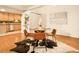 A modern dining area with sleek glass table and seating, adjacent to the kitchen at 1140 Columbine St # 106, Denver, CO 80206