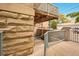 Exterior view of a private patio, stone detail, and a glimpse of the surrounding neighborhood at 1140 Columbine St # 106, Denver, CO 80206
