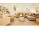 Bright and airy living room featuring built-in shelving, a comfortable sectional, and large windows at 1140 Columbine St # 106, Denver, CO 80206