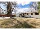 Large backyard with a patio, mature trees, and ample space for outdoor activities at 3400 S Ivy Way, Denver, CO 80222