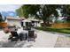 Relaxing backyard oasis with a patio, outdoor seating, and lush greenery, ideal for leisure and gatherings at 3400 S Ivy Way, Denver, CO 80222