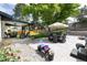 Spacious backyard featuring mature trees, outdoor seating, and a stone patio at 3400 S Ivy Way, Denver, CO 80222