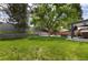 Expansive backyard with lush lawn, mature trees, and outdoor seating area at 3400 S Ivy Way, Denver, CO 80222