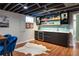 Basement bar featuring a wine fridge and blue tile backsplash at 3400 S Ivy Way, Denver, CO 80222