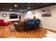 Finished basement with a comfortable seating area, bar, and hardwood floors at 3400 S Ivy Way, Denver, CO 80222