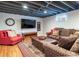 Finished basement featuring comfortable seating and a modern television at 3400 S Ivy Way, Denver, CO 80222