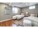 Bright bedroom with two twin beds, plush decor, and a large mirror at 3400 S Ivy Way, Denver, CO 80222