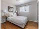 Relaxing bedroom featuring neutral decor and hardwood floors at 3400 S Ivy Way, Denver, CO 80222