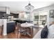 Stylish dining area with an elegant chandelier, seamlessly connecting to the kitchen at 3400 S Ivy Way, Denver, CO 80222