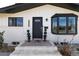 Elegant entrance featuring a stylish front door, bay window, and brick accents at 3400 S Ivy Way, Denver, CO 80222