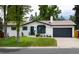 Charming one-story home with a well-maintained lawn and black garage door at 3400 S Ivy Way, Denver, CO 80222