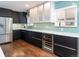 Sleek kitchen with stainless steel appliances, wine cooler, and chic backsplash at 3400 S Ivy Way, Denver, CO 80222