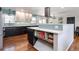 Bright kitchen featuring a center island, modern appliances, and stylish backsplash at 3400 S Ivy Way, Denver, CO 80222