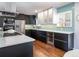Modern kitchen with sleek cabinetry, stainless steel appliances, and aqua backsplash at 3400 S Ivy Way, Denver, CO 80222
