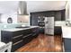 Modern kitchen with stainless steel appliances, and sleek black cabinetry at 3400 S Ivy Way, Denver, CO 80222