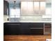 Stylish kitchen with stainless steel appliances, wine fridge, and modern backsplash at 3400 S Ivy Way, Denver, CO 80222