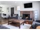 Comfortable living room featuring a brick fireplace and hardwood floors at 3400 S Ivy Way, Denver, CO 80222