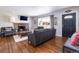 Cozy living room with a brick fireplace, hardwood floors, and ample natural light at 3400 S Ivy Way, Denver, CO 80222