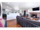 Open-concept living room with modern decor, fireplace, and seamless flow to kitchen at 3400 S Ivy Way, Denver, CO 80222