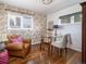 Charming home office with hardwood floors, a glass desk, and unique wallpaper at 3400 S Ivy Way, Denver, CO 80222