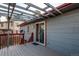 Back deck with wood railings and a sliding glass door entry into the home at 18874 E Mexico Dr, Aurora, CO 80017