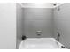 Tiled bathtub and shower, featuring a plant in the corner at 18874 E Mexico Dr, Aurora, CO 80017