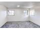 Bright bedroom with large windows and neutral colored walls and new carpet at 18874 E Mexico Dr, Aurora, CO 80017