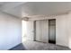 Bedroom with large closet and neutral colored walls and flooring at 18874 E Mexico Dr, Aurora, CO 80017