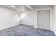 Comfortable bedroom with large closet, neutral colored walls, carpet, and a large window at 18874 E Mexico Dr, Aurora, CO 80017