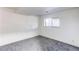 Bright room with neutral colored walls, carpet, and a large window at 18874 E Mexico Dr, Aurora, CO 80017