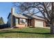 Charming exterior of home featuring brick and siding with a two-car garage and well-maintained lawn at 18874 E Mexico Dr, Aurora, CO 80017