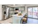 Modern kitchen featuring stainless steel appliances, a center island with seating, and elegant countertops at 18874 E Mexico Dr, Aurora, CO 80017