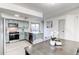 View of the kitchen featuring an island, stainless steel appliances, and breakfast nook with a sliding glass door at 18874 E Mexico Dr, Aurora, CO 80017