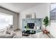 Bright living space featuring a cozy fireplace, large windows, and a comfortable sofa at 18874 E Mexico Dr, Aurora, CO 80017