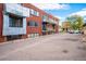 Brick apartment building exterior with parking and small balconies in an urban setting at 75 N Emerson St # 104, Denver, CO 80218