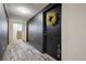 Interior hallway featuring unit door with wreath and access to staircase at 75 N Emerson St # 104, Denver, CO 80218